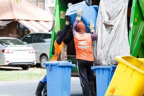 Professional movers sorting items for house clearance